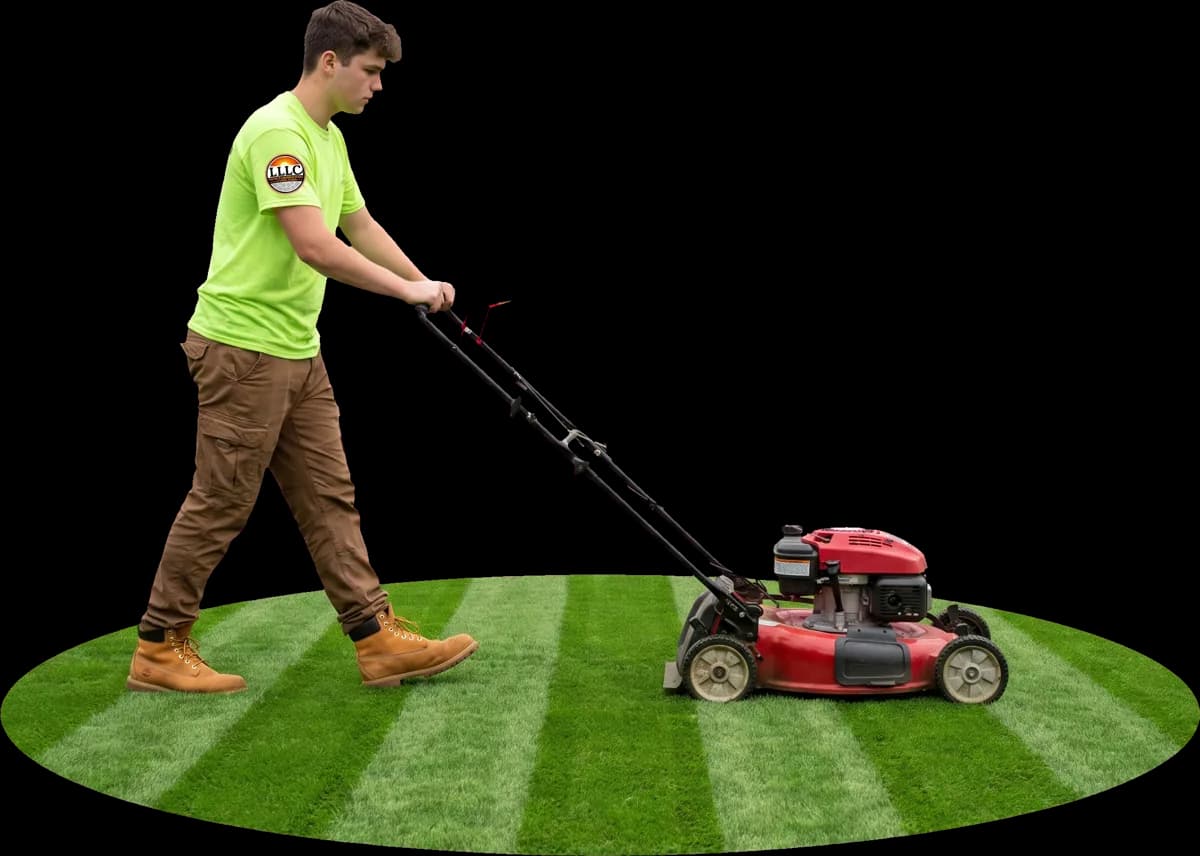 Lofton crew member mowing a striped patch of grass