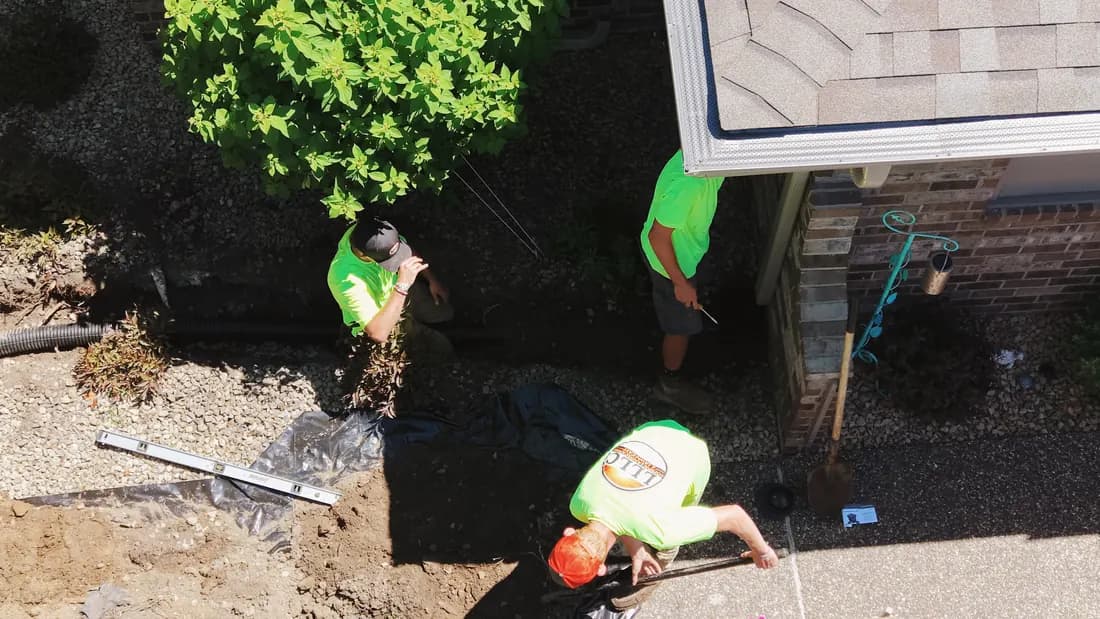 Overhead view of the Lofton crew trenching and rebuilding a bed along a house