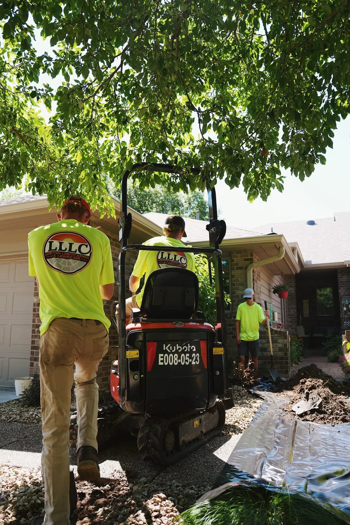 Lofton crew installing landscaping with a mini excavator