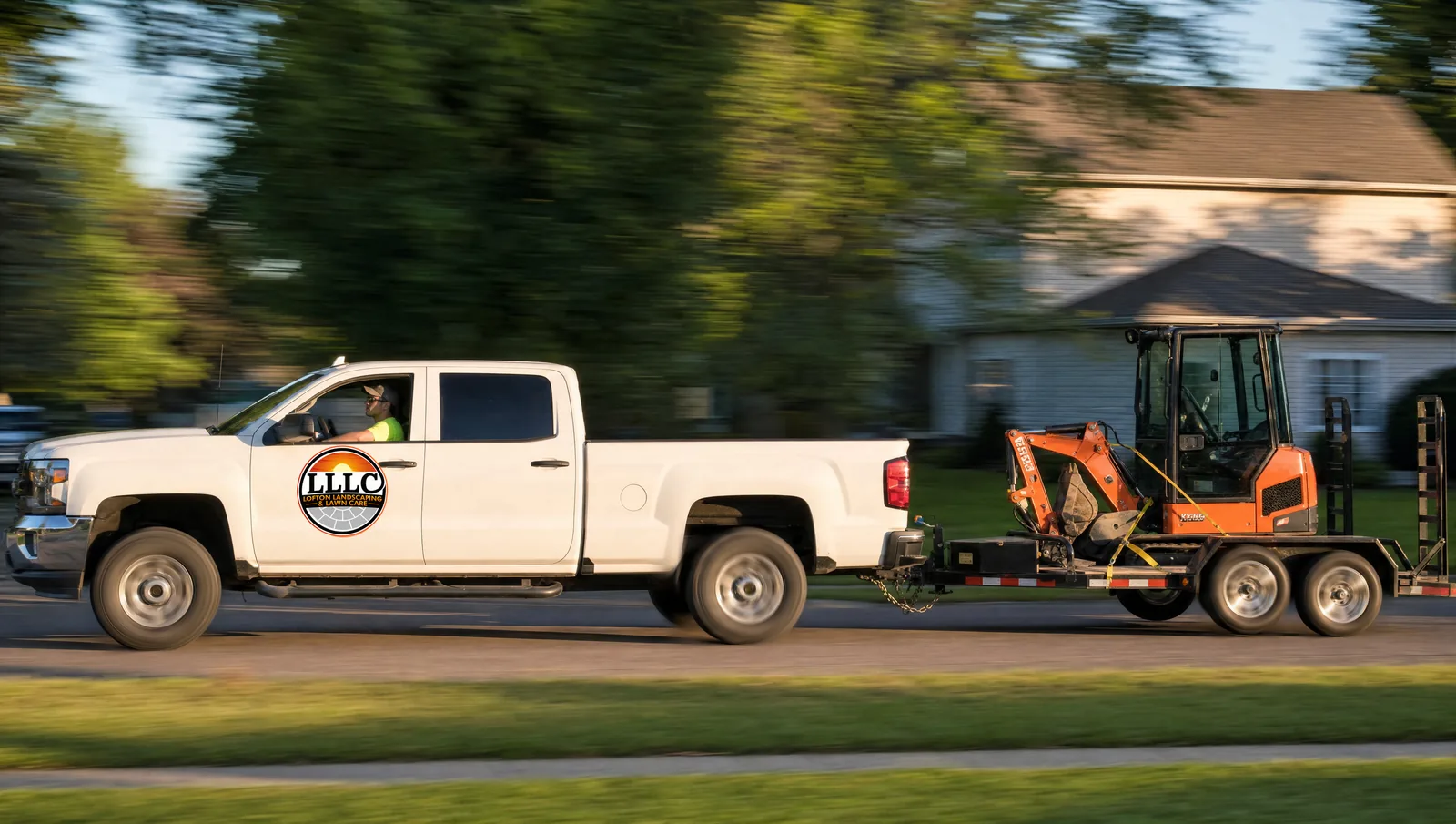 Lofton Landscaping truck hauling the mini excavator out on the south metro route
