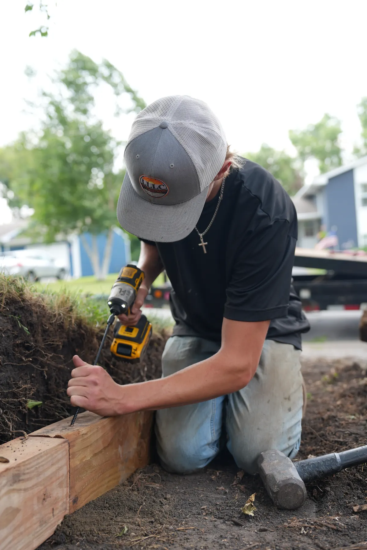 Lofton crew shaping clean bed lines in front yard