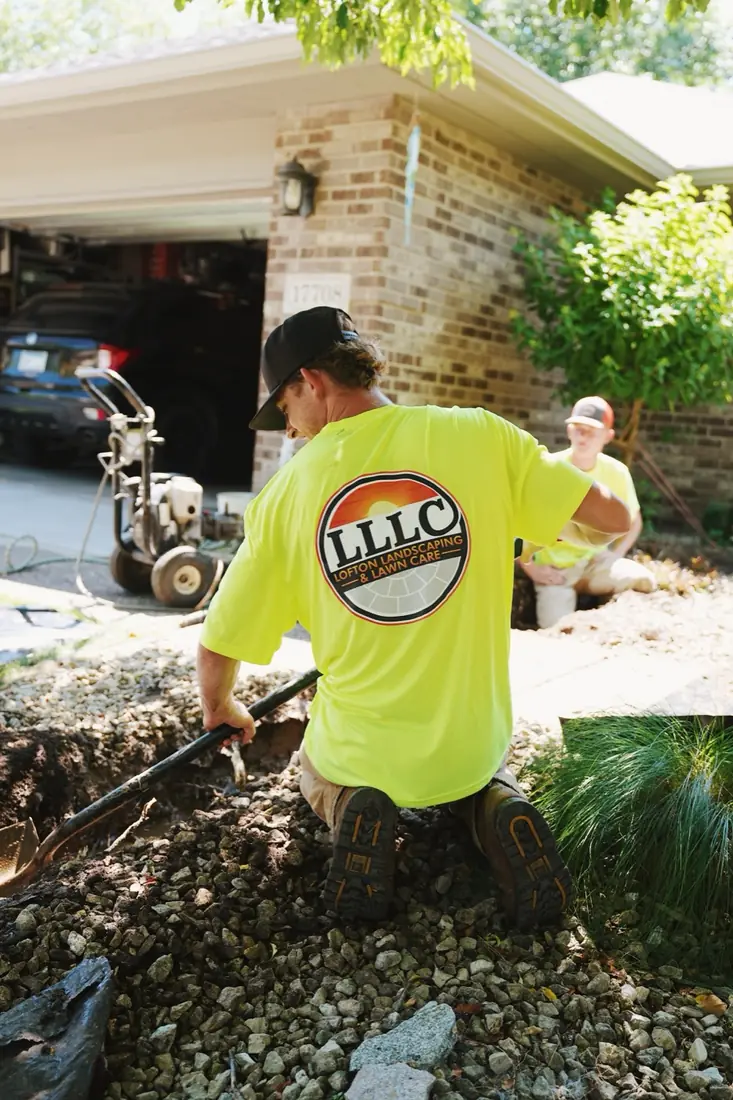 Crew member raking out a bed in uniform