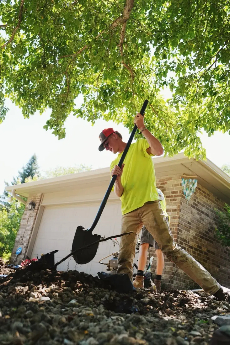 Crew member digging a new bed edge